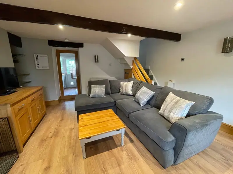 Sitting room with corner sofa and exposed beams